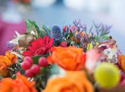 A lovely bouquet featuring bright oranges and reds